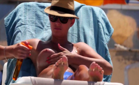 Beach Voyeur Finds A Busty Blonde Babe Enjoying The Hot Sun